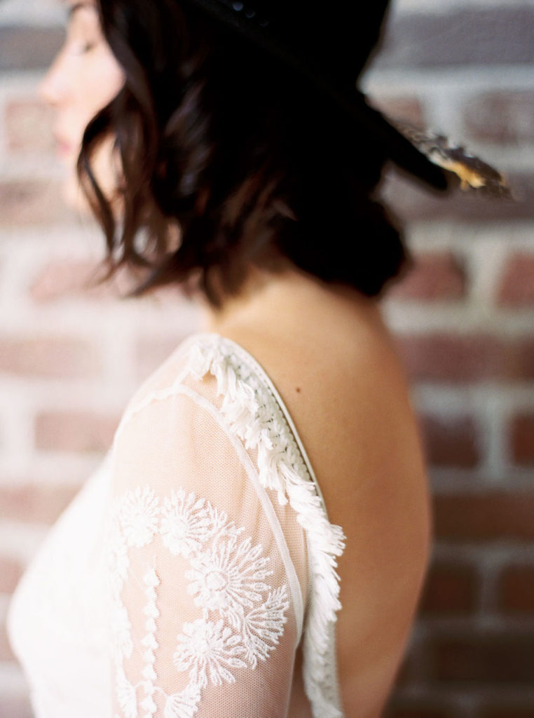Side view of woman wearing backless white lace gown by DC bridal photographer Kim Branagan