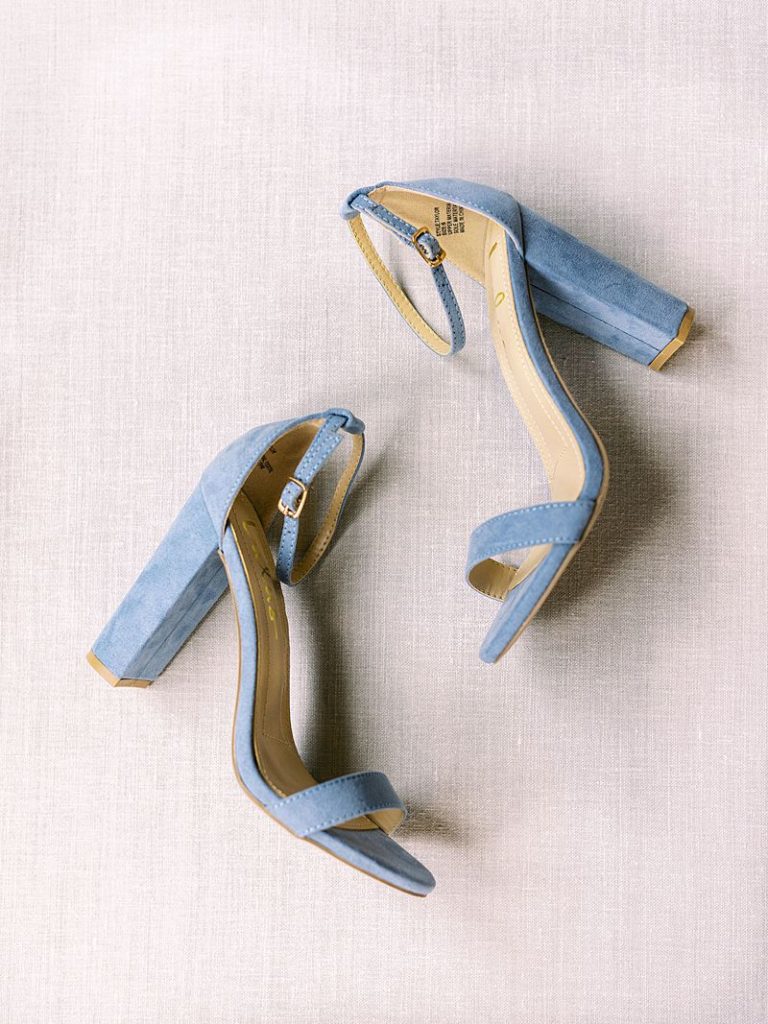 blue high heel wedding shoes laying on the floor