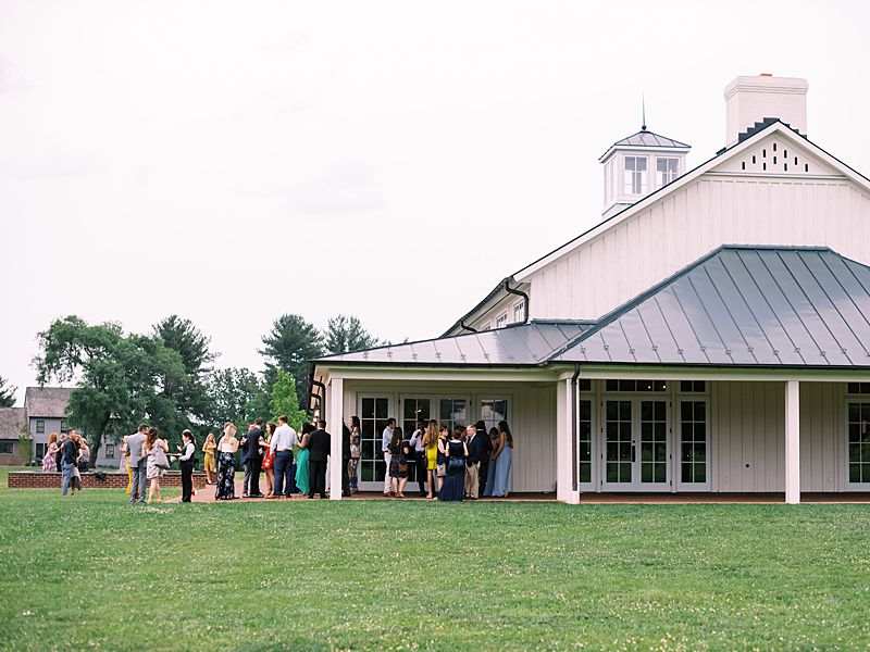 wedding guests stand outside during a wedding at King Family Vineyards