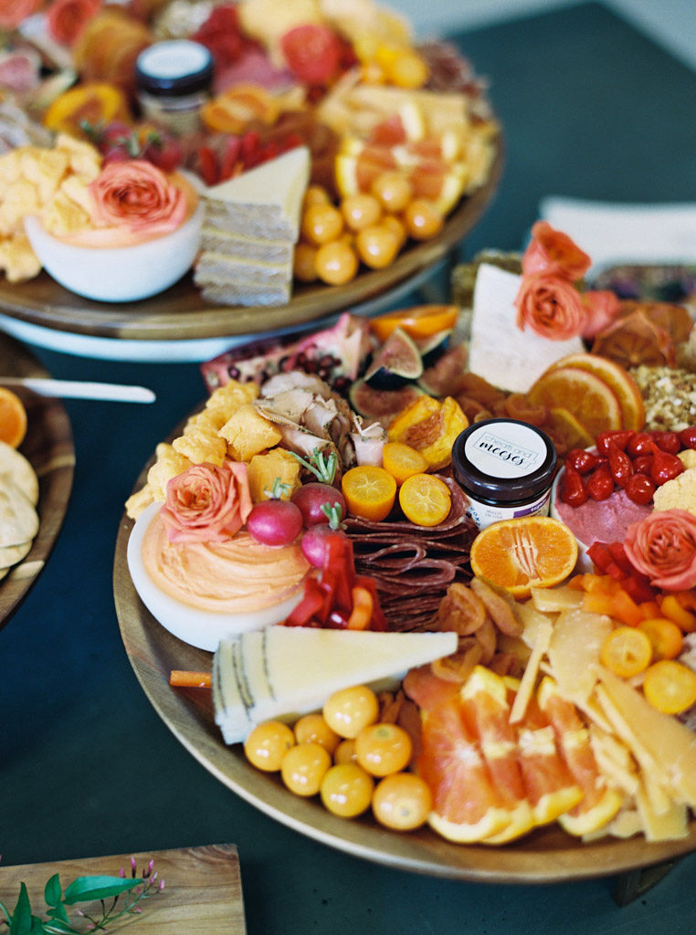 A closeup shot of two charcuterie boards, with various meats, cheeses, vegetables, fruits, and dips on the platters. Shot by Washington D.C. and Virginia commercial photographer Kim Branagan.