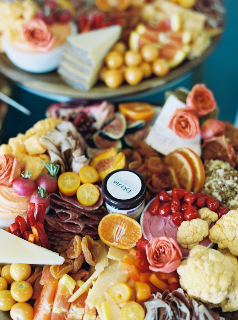 A closeup shot of a snack platter with various meats, cheeses, vegetables, fruits, and dips. Shot by Washington D.C. and Virginia commercial photographer Kim Branagan.