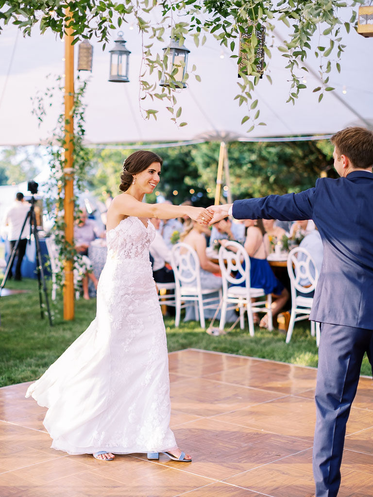 A bride and groom dance on the outdoor dance floor at their wedding reception.Photo by Virginia and Washington D.C. wedding photographer Kim Branagan.