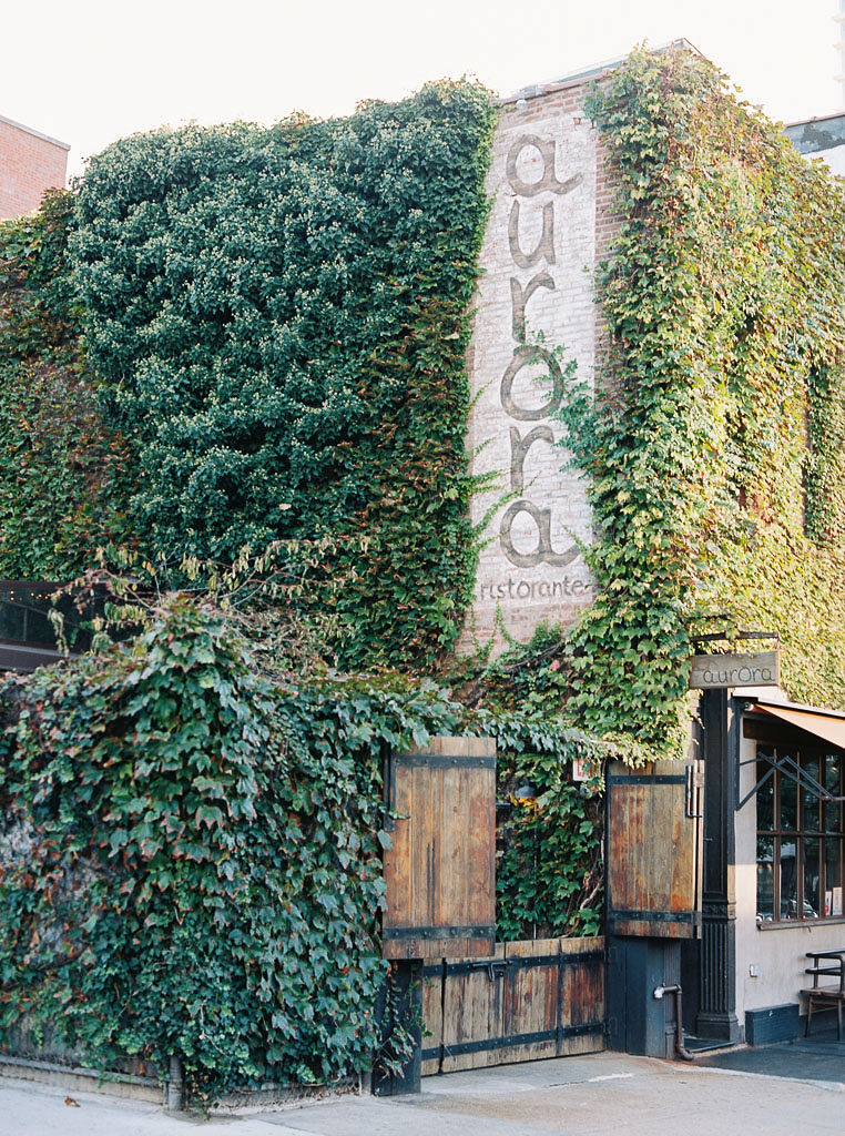Exterior view of a vine-covered wall at Aurora restaurant in Williamsburg, Brooklyn.