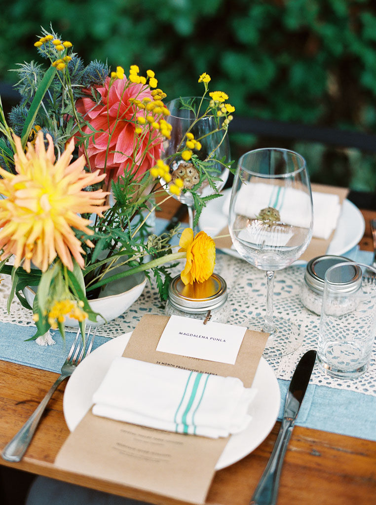 Simple, garden-themed place settings on a table at a wedding reception at Aurora restaurant in Williamsburg, New York.