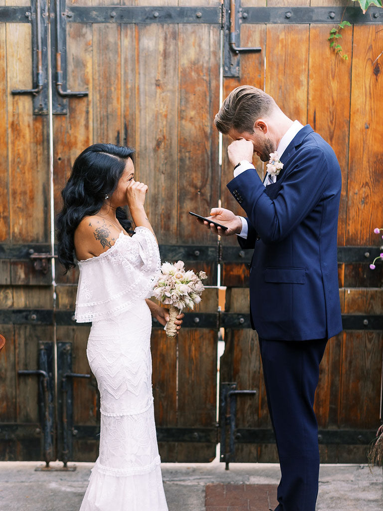 A couple wipes away tears during their wedding ceremony.