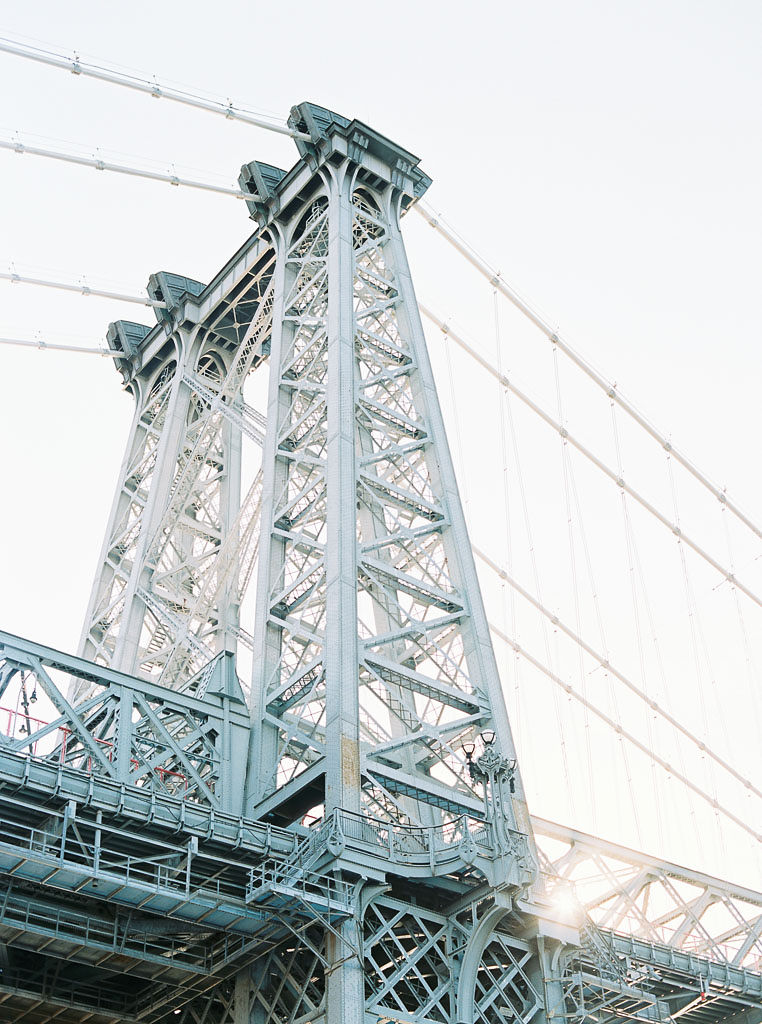 A pillar and suspension cables that are part of the Williamsburg bridge