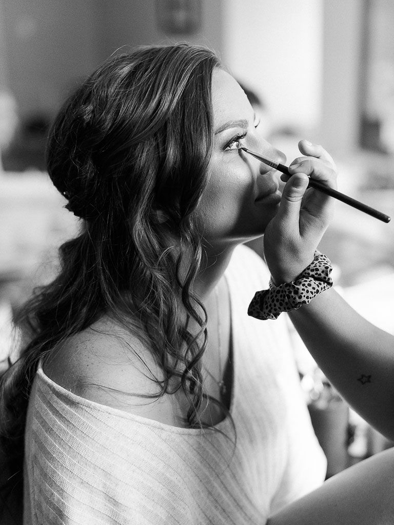 The bride having her makeup done on her wedding day. Photographed by northern Virginia wedding photographer Kim Branagan.