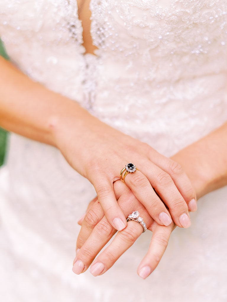 Close up shot of the bride's hands. She is wear two rings, including her ornate engagement ring. Photographed by northern Virginia wedding photographer Kim Branagan.