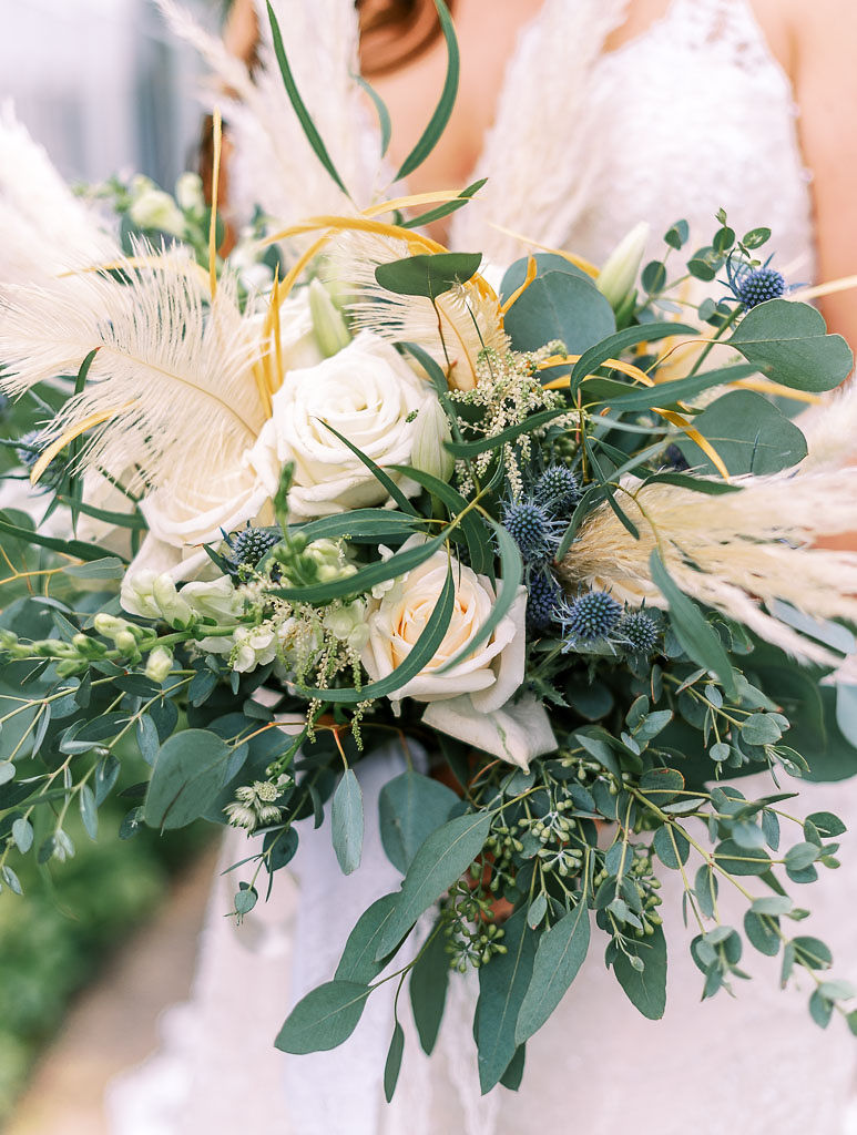 Close up shot of the bride's neutral-toned bouquet of fall flowers.