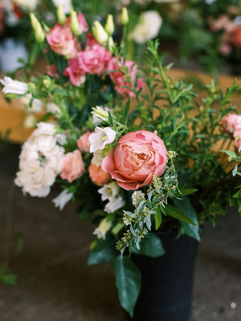 Pink, blush, and ivory flowers in a bucket to be used in bouquets and floral centerpieces. Photographed by Alexandria, VA commercial photographer Kim Branagan
