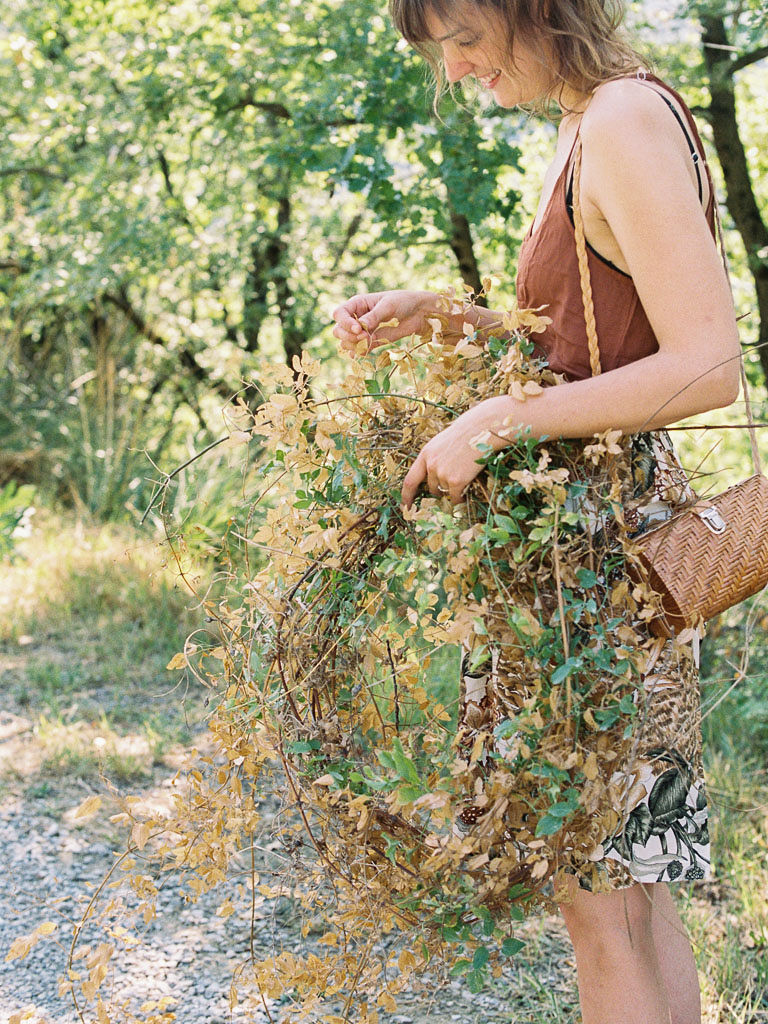 A woman holds the flowers she found in the Italian countryside to use for a floral arrangement. Clarity Retreat - A Floral Workshop by Ponderosa & Thyme | Florence, Italy. Photographed by Florence brand and editorial photographer Kim Branagan.