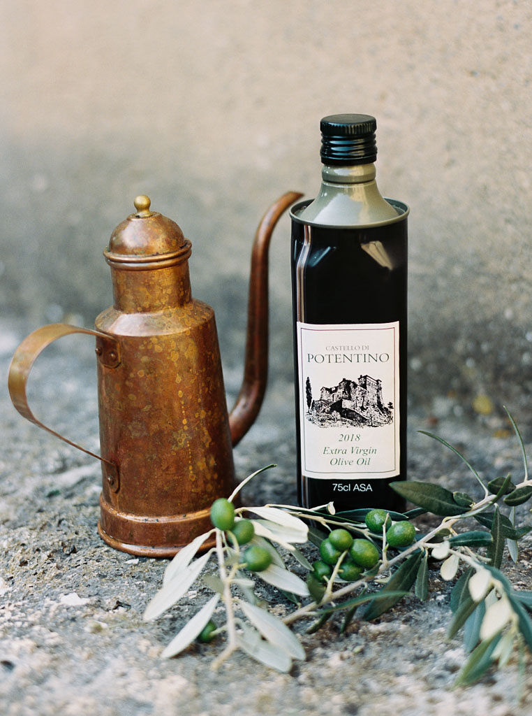 Olive oil and a olive branches with a copper container. Clarity Retreat - A Floral Workshop by Ponderosa & Thyme | Florence, Italy. Photographed by Florence brand and editorial photographer Kim Branagan.